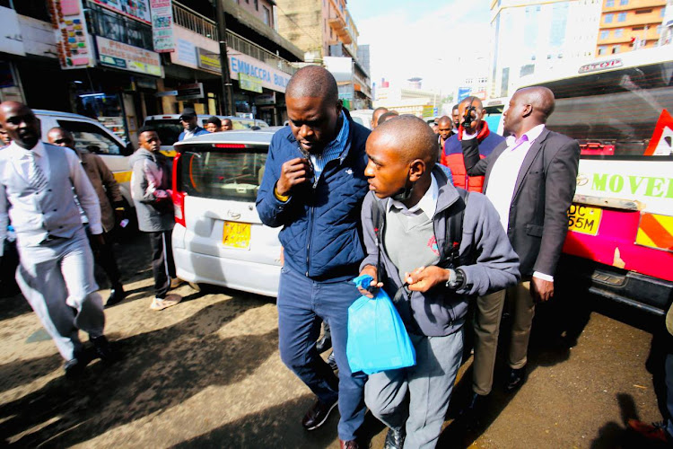 Nairobi Governor Johnson Sakaja interacting with a student stranded at CBD after government postponed school reopening dates on Monday, April 29, 2024.