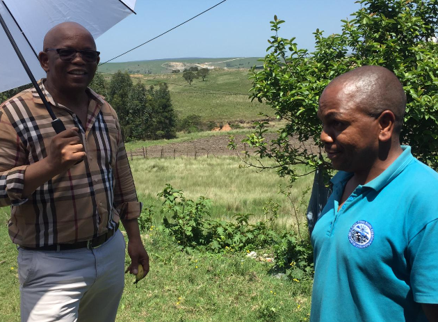 Eastern Cape MEC for transport Xolile Nqatha (left) and resident Lubabalo Vumba at Jama village, outside Bizana.