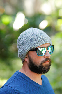 man wearing a gray crochet beanie