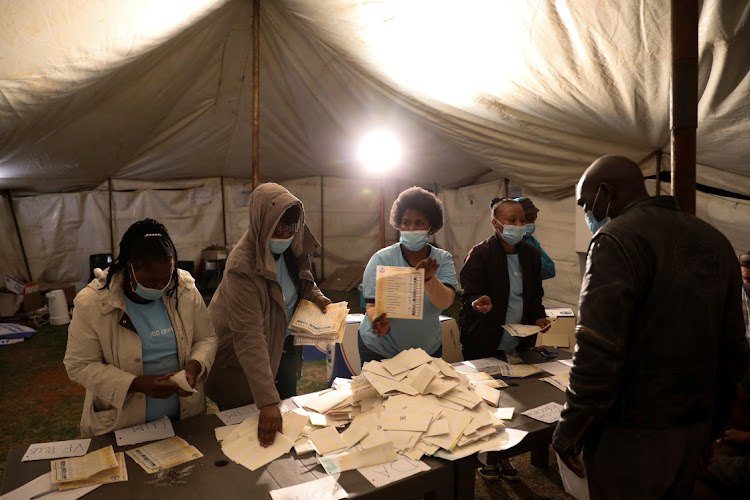 Election officials count ballots after the closing of the local government elections at a farm in Alewynspoort, outside Johannesburg, on Monday night.