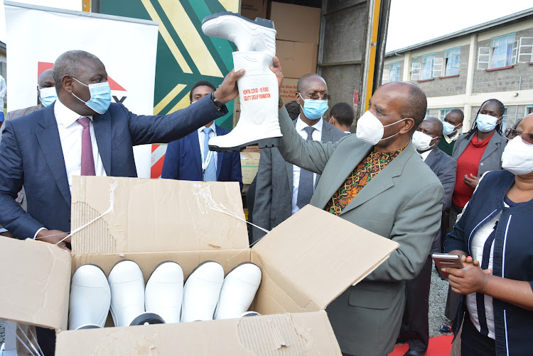 Equity Bank CEO James Mwangi hands over PPE to Nyandarua Governor Francis Kimemia for use in Engineer Level 4 Hospital in Kinangop, Nyandarua county.