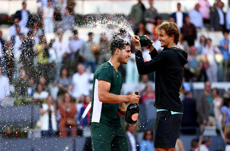 Carlos Alcaraz of Spain celebrates with champagne after his straight sets victory during the Men's Singles final match against Alexander Zverev of Germany during day eleven of Mutua Madrid Open at La Caja Magica on May 08, 2022 in Madrid, Spain.