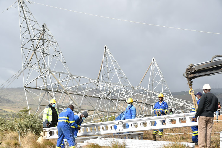 Kenya Power and Kenya Electricity Transmission Company workers repair a broken electricity pylon at Longonot.