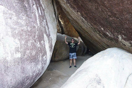 Don Bucolo of Cruiseable poses in a boulder-enclosed cave at The Baths on Virgin Gorda, British Virgin Isles.