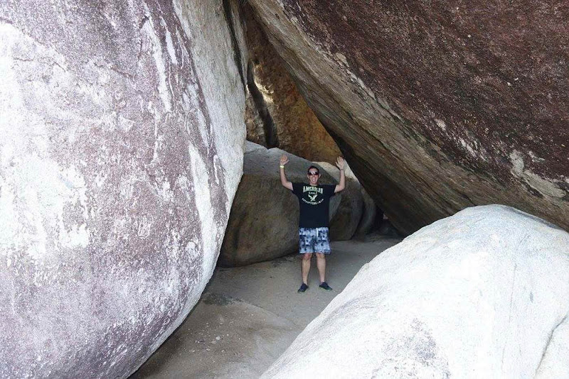 The author poses in a boulder-enclosed cave at The Baths on Virgin Gorda.