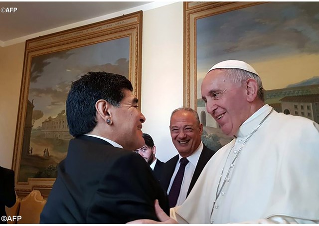 Pope Francis speaks to Diego Maradona ahead of a charity soccer match on Wednesday. - AFP