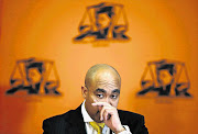 PICTURE OF INNOCENCE: Head of the National Prosecuting Authority Shaun Abrahams gestures as he announces the dropping of fraud charges against Finance Minister Pravin Gordhan during a media briefing in Pretoria yesterday