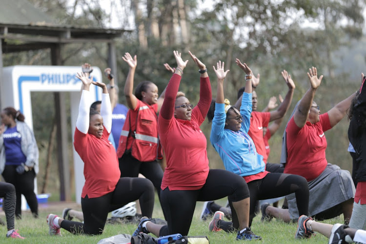 Participants warm up before the cycling challenge.