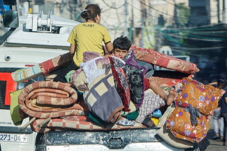 Palestinians flee their Gaza City homes during Israeli strikes in the conflict between Israel and the Palestinian Islamist group Hamas on October 13 2023. Sources said Egypt, Israel and the US have agreed to a temporary ceasefire in southern Gaza on Monday. File photo.