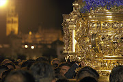 A procession heads for the central cathedral during 'Semana Santa'.