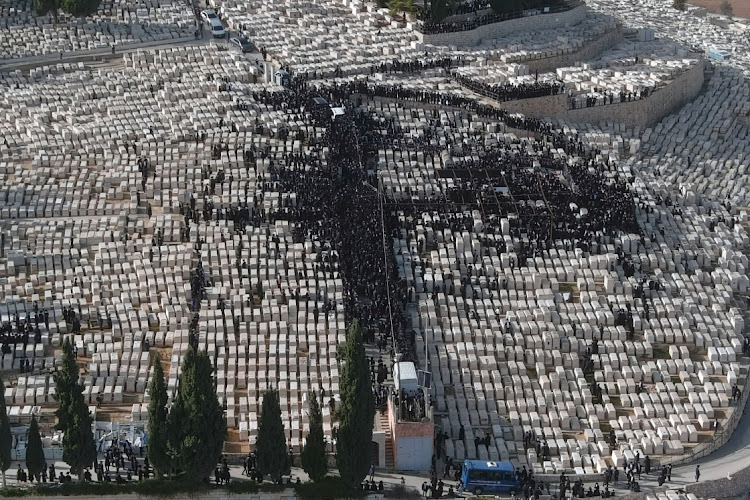 An aerial view shows Ultra Orthodox Jews taking part in a funeral of a Jewish spiritual leader amid the coronavirus disease ( Covid-19) restrictions in a cemetery in Jerusalem January 31, 2021. Picture taken with a drone.