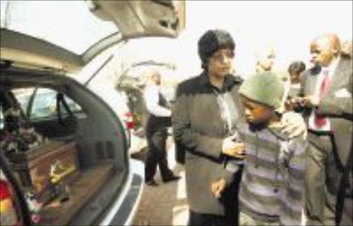 COMFORTING HANDS: Winnie Madikizela-Mandela with explosion survivor Sipho Ndlovu at the St Martin's Catholic Church in Killarney, Soweto, on Saturday. Pic: VELI NHLAPO. 10/08/2009. © Sowetan.