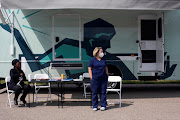 Nurses wait for people to come by to receive their coronavirus disease (Covid-19) vaccine at a mobile pop-up vaccination clinic hosted by the Detroit Health Department.