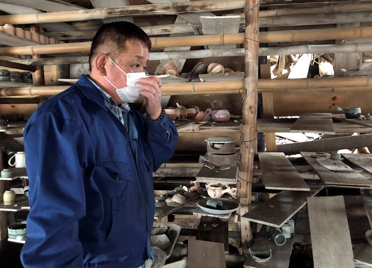 Toshiharu Onoda, of the 13th generation to take on the family pottery business, looks at his studio damaged by 2011 earthquake and tsunami that crippled the Fukushima Daiichi nuclear power plant, Japan, on March 8 2021. Picture: REUTERS/ELAINE LIES