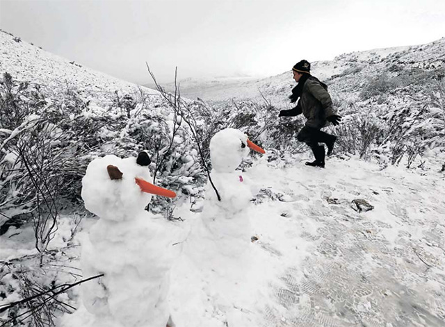 A child plays in the snow on the Swaarmoed Pass, 10km outside Ceres in the Western Cape. Despite floods and the freezing weather conditions, residents and visitors are flocking to the Ceres area to enjoy the snow.