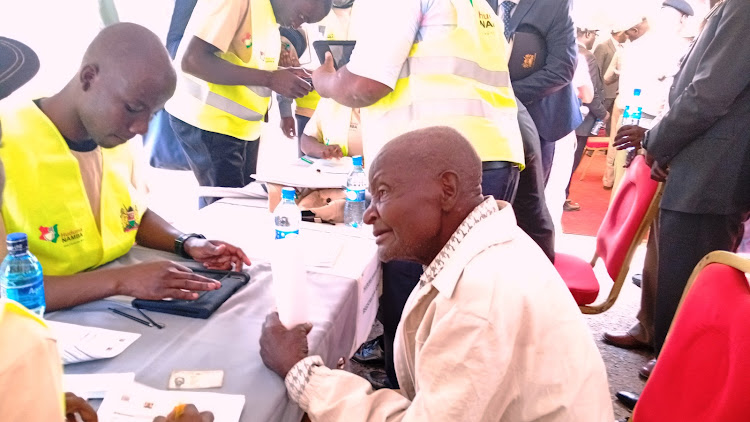 Mzee Enock Shicveka registering for NIIMS at Kambi Mwanza market in Malava subcounty