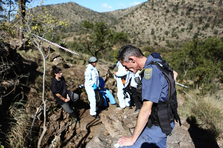 Police conduct DNA tests on possible relatives of dead men found in cave.