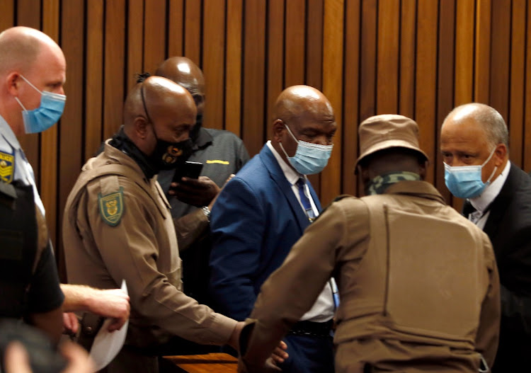 Richard Mdluli flanked by Correctional Service officials who escorted him to court today.