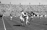 St Helen's Tom van Vollenhoven passes the ball inside as he is tackled by Wigan's F Griffiths.