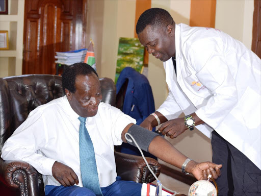 Star journalist Joseph Jamenya takes the blood pressure for Vihiga governor Dr Wilber Ottichilo in his office on September 28,2017