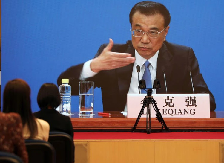 Chinese Premier Li Keqiang is seen on a screen during a news conference held via video link, following the closing session of the National People's Congress (NPC) in Beijing, China March 11, 2021.