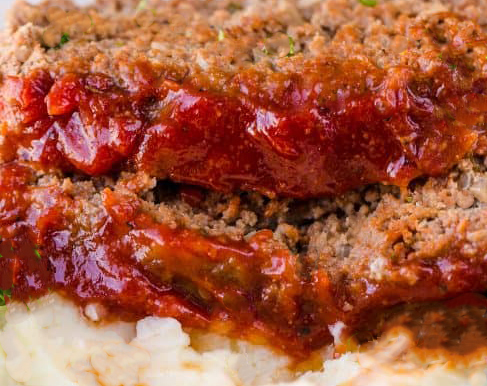 Meatloaf enhanced with a robust sauce. 