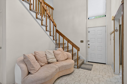 Entrance hall with stairs and sofa in this luxury apartment / penthouse for rent in Roslyn ($7,200)