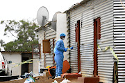 A member of the forensic team gathers evidence at the scene where seven people were gunned down during a raid at the Mancoba church premises in Engcobo last month. 