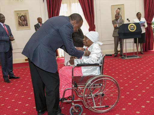 President Uhuru Kenyatta bestows The Elder of the Order of the Burning Spear (E.B.S.) to Ms. Mukami Elois Kimathi at State House, Nairobi.pscu