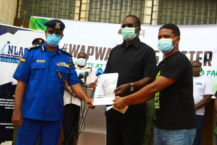 Coast regional police commander Rashid Yakub, regional coordinator John Elungata and Haki Sfrica executive director Hussein Khalid at the Uhuru na Kazi builing in Mombasa on Friday.