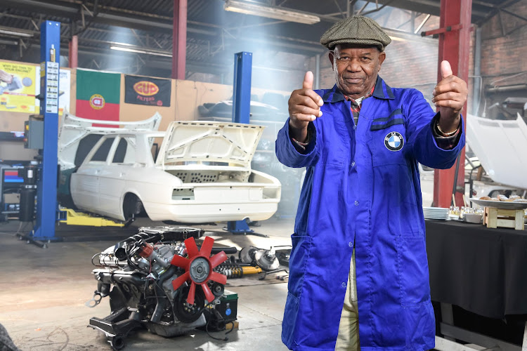 William Mokwape, a retired BMW employee who built the BMW 530 Motorsport Limited Edition behind him in 1976, prepares to refit the motor.