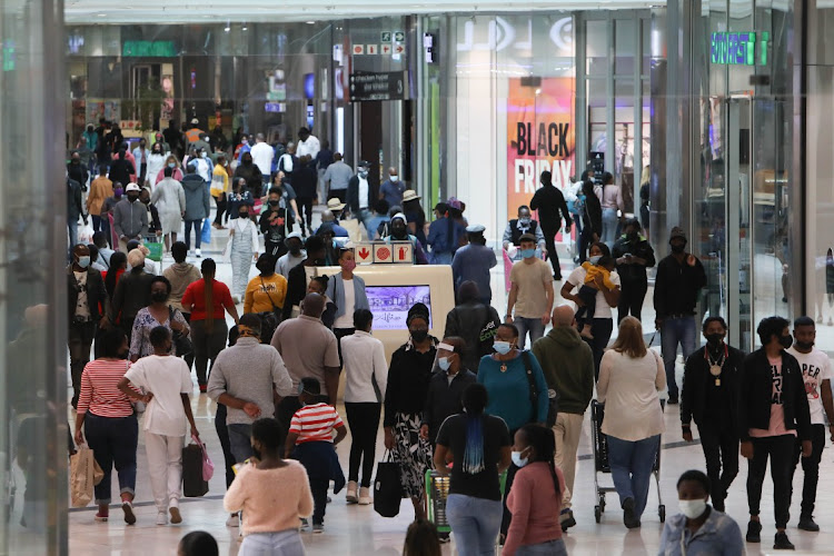 Shoppers make their way through the Mall of Africa in Midrand, Johannesburg, during Black Friday November 26 2021.