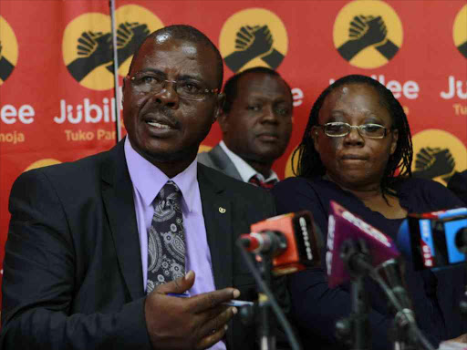 Jubilee disciplinary committee chairman Muchai Lumatete addresses the press at the party's headquarters, over chaos at county board elections, flanked by deputy chair Wanjiku Nduati and secretary general Raphael Tuju, March 28, 2017. /MONICAH MWANGI