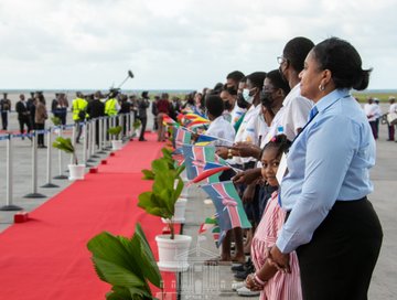 People line up to receive President Uhuru Kenyatta at Seychelles International Airport on Mahe Island.