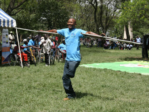 Pete Mburu, an artiste living with disability, performs at Nyayo Gardens in Nakuru during a 2015 event to mark the International Day of Persons with Disabilities. /FILE