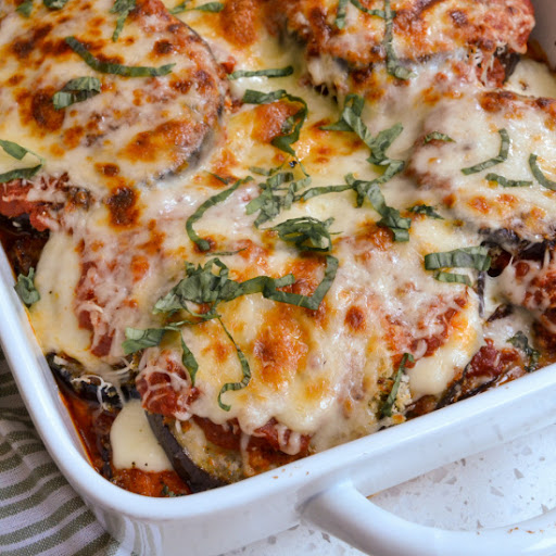 A delicious traditional Eggplant Parmesan casserole made with pan fried crispy eggplant, marinara, mozzarella, Parmesan, and fresh basil.