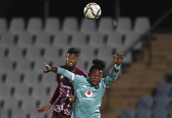 Kwame Peprah of Orlando Pirates challenges Yagan Sasman of Swallows FC in the DStv Premiership match at Dobsonville Stadium in Johannesburg on December 14 2021.