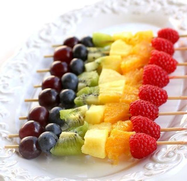 A rainbow of fruit on skewers

Description automatically generated
