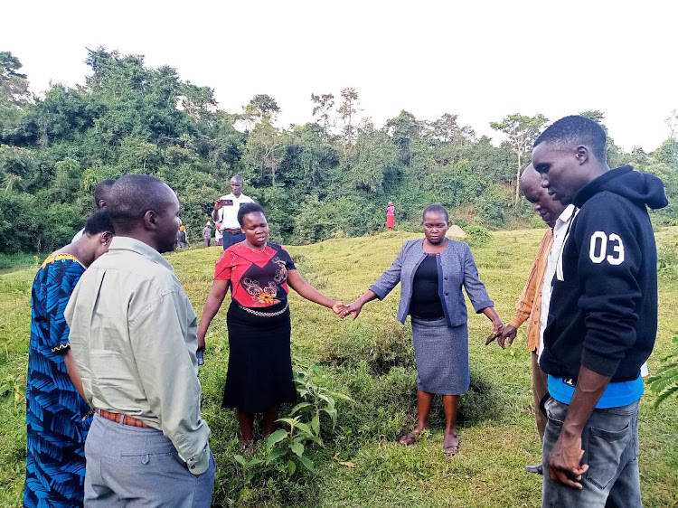 Family members of the three KWS scouts who drowned in river Isiukhu in Kakamega forest, on Wednesday.