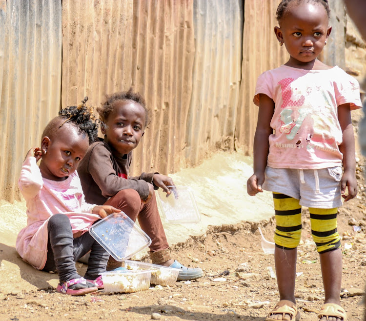 Mathare children Joy, Peninah and Ivy enjoy the food aid