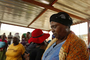 BARBERTON, SOUTH AFRICA - FEBRUARY 9: Family members of the three mineworkers who are trapped underground at the Lily Mine praying on February 9, 2016 in Barberton, South Africa. Two women, Yvonne Mnisi and Pretty Mabuza, and one man, Solomon Nyarenda, remain trapped in a metal container underground after a central pillar of ore, called a crown pillar, collapsed last Friday. (Photo by Gallo Images / Sowetan / Vathiswa Ruselo)..