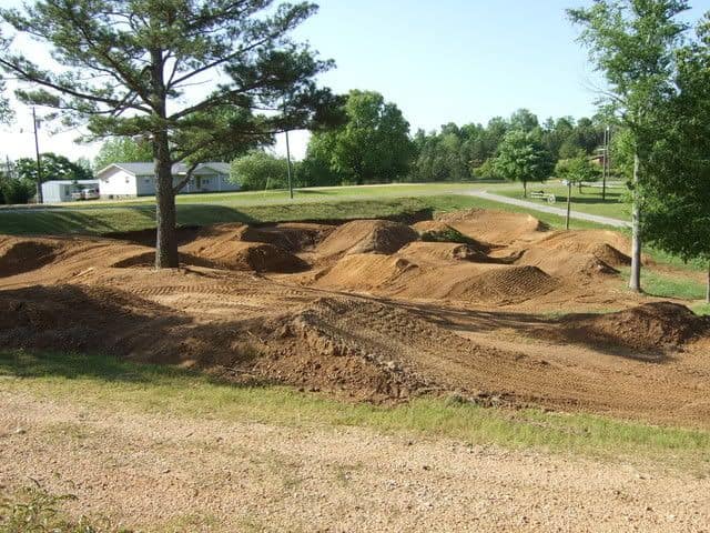 A homemade dirt bike off-roading track with a lot of short hills to jump over. 