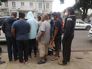 Durban residents queue to buy bread rolls from a car in Musgrave.