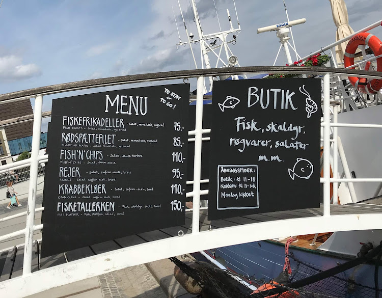 A menu in Danish at a fish restaurant on a boat along the waterfront of Copenhagen. 