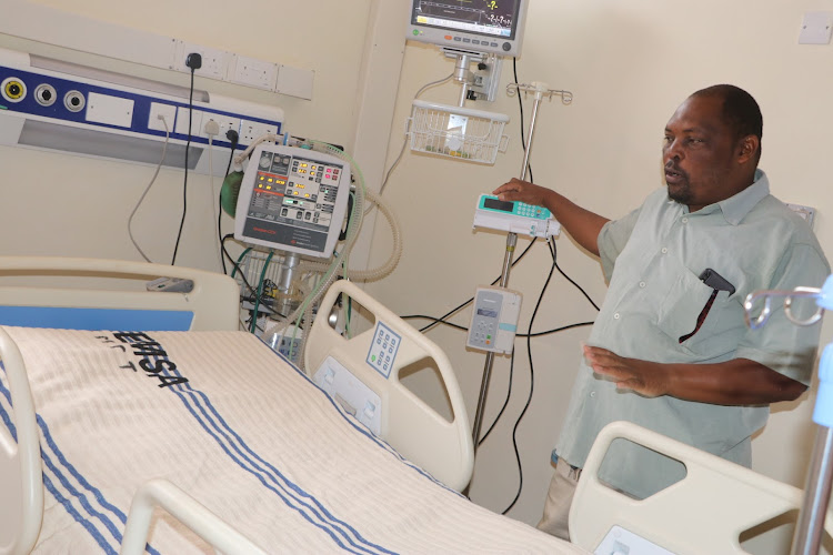 Williamson Kaunda, an ICU nurse explains about the new ICU equipment a the Mwatate Subcounty hospital on July 21
