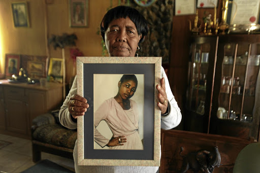 Grieving mother Sizakele Simelane with a portrait of her daughter Nokuthula, in Bethal, Mpumalanga. /KEVIN SUTHERLAND