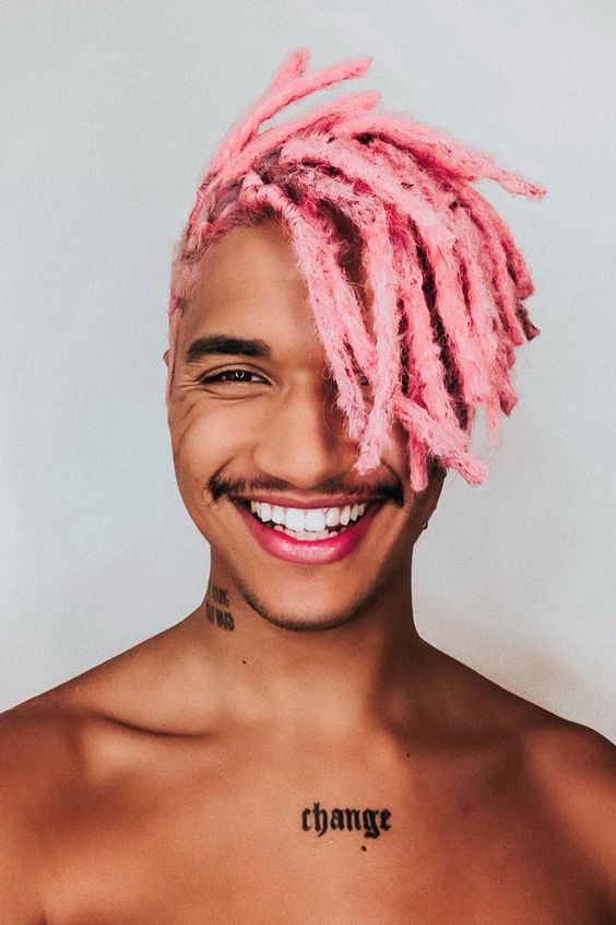 smiing guy rocking pink dreadlocks