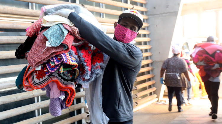 Siya Kolisi carries some of the blankets donated by the volunteers at 67 Blankets, an organisation with which he has now teamed up