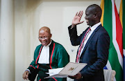 Ronald Lamola and Chief Justice Mogoeng Mogoeng share a light moment as Lamola is sworn in as Minister of Justice and Correctional Services.