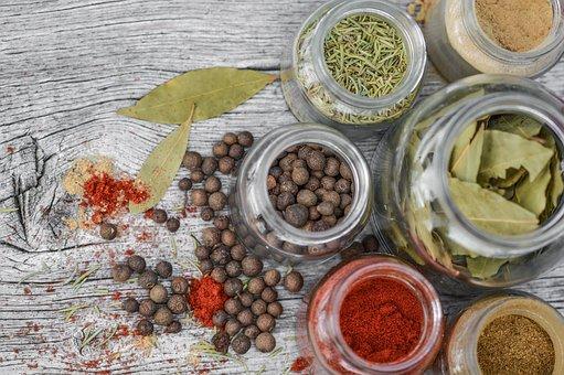 Spices, Jars, Herbs, Herbs And Spices on a rustic wooden table.